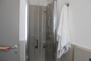 a shower in a bathroom with a glass door at SulMare Alba Adriatica in Alba Adriatica +71 photos