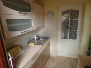a kitchen with a sink and a microwave at Apartament CURIE - studio in Międzyzdroje