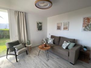 a living room with a couch and a chair at Apartamerica 471, Gartenwohnung, Pool, 150 M zum Strand, Las Americas in Costa de Adeje