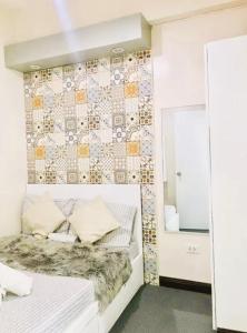a bedroom with a white bed with a wall with a mural at Close by landmarks and airport in Manila +10 photos