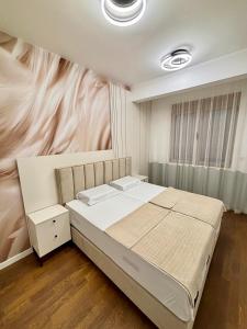 a bedroom with a bed with a painting on the wall at Bella Vista Pleasure in Baošići