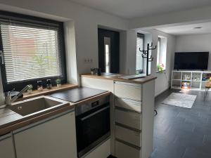 a kitchen with a sink and a counter top at Ferienwohnung Thermenblick in Bad Windsheim +6 photos