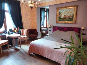 a bedroom with a bed and a table and chairs at L'auberge Beauraing in Baronville +14 photos