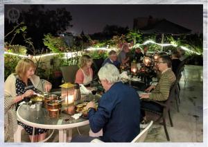 a group of people sitting at tables at a party at Colonel’s Retreat in New Delhi