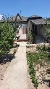 a house with a sidewalk in front of it at Halal House Vip in Qusar