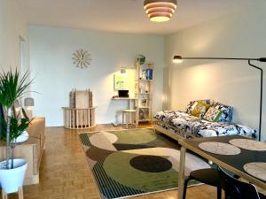 a living room with a couch and a table at Moomin Lover Home in Central Helsinki - Pool & Sauna in Helsinki +29 photos