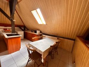 a kitchen with a table and chairs in a room at Noclegi Fikusówka in Opole
