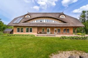 an image of a house with a thatched roof at Vila Sanzila in Bernatoniai