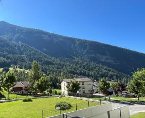 a view of a town with a mountain in the background at Family friendly duplex with free parking in Leukerbad