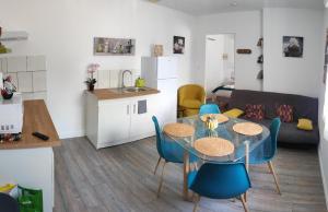 a kitchen and a dining room with a table and chairs at Le Haut Berry in Les Aix-dʼAngillon