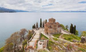 an old building on the edge of a body of water at Maja Apartments in Ohrid