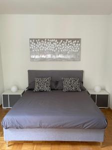 a bed in a bedroom with two night stands at Torretta House in Locarno