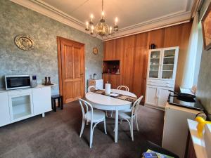 a kitchen and dining room with a table and chairs at Le Manoir W in Waimes