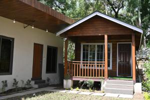 a small house with a porch and a door at Royal cottage by royale palace in Mount Ābu