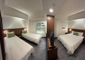 Postel nebo postele na pokoji v ubytování Hub Hotel Kaohsiung Cisian Branch