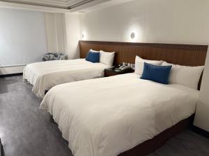Postel nebo postele na pokoji v ubytování Hub Hotel Kaohsiung Cisian Branch