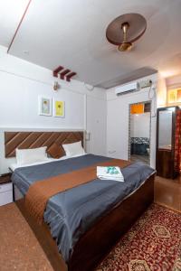 a bedroom with a bed and a ceiling at Shanti krishna Residency Gokarna in Gokarna