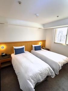 Postel nebo postele na pokoji v ubytování Hub Hotel Kaohsiung Cisian Branch