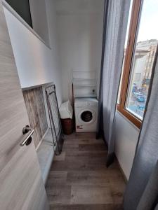 a laundry room with a washing machine and a window at La Risacca in Pietra Ligure +26 photos