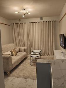 a living room with a couch and a table at Homely Homes in Eldoret