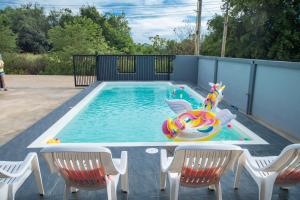 a swimming pool with a inflatable toy in the water at Lunar pool villa sattahip in Ban Tao Than