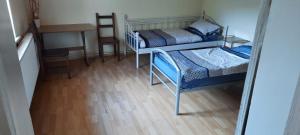 a small room with two bunk beds and a table at Am Borsumer Pass in Algermissen