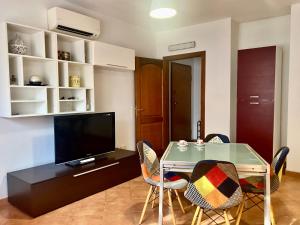 a dining room with a glass table and chairs at Rose House in Olbia
