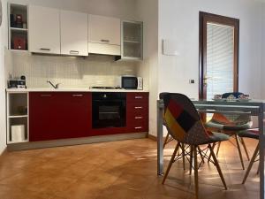 a kitchen with a table and some chairs in a room at Rose House in Olbia