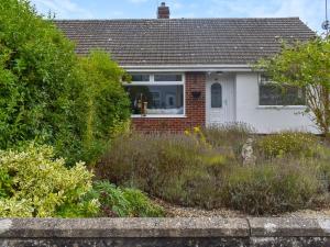a white house with a garden in front of it at Seashells in Lowestoft