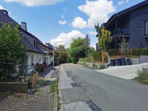 an empty street in a residential neighborhood with houses at Lier Stays in Meschede