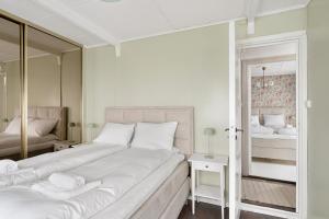 a bedroom with a large bed and a mirror at City Center Gem I Traditional Bergen Style in Bergen