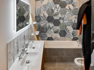 a bathroom with a sink and a tub and a toilet at Bolingey Chapel in Perranporth +2 photos