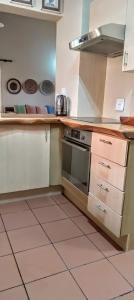 a kitchen with a sink and a stove top oven at UrbanEscape in Centurion