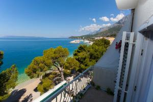 a balcony of a building with a view of the ocean at Villa Ankora Apartments Tučepi in Tučepi