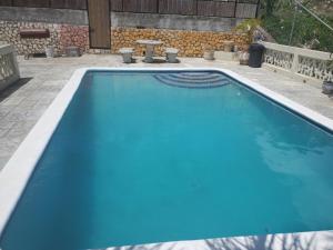 a large swimming pool with blue water in a yard at Bayview Luxury Retreat 