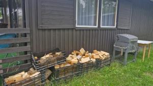 a pile of wood in baskets next to a building at Chata Ještěrka in Doksy