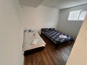 a small room with a bed and a small bed sidx sidx sidx at DAMIEN apartments in Ohrid