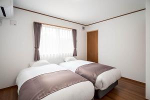 Una cama o camas en una habitación de Fuji Mason's Villa
