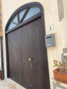 a black door with a window on a building at Casa Joe in San Vito lo Capo