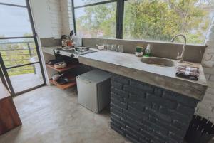 a kitchen with a sink and a large window at REZ SPACE Apartment 01 in Hiriketiya +9 photos