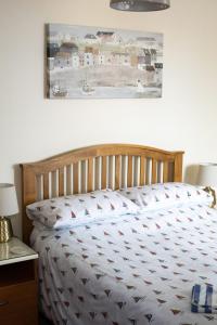 a bed in a bedroom with a picture on the wall at Lot 1 The Old Auction Room in Whitby