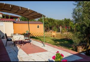 a patio with a table and an umbrella at Liopetra in Serres