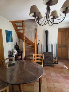 a dining room with a table and a wood stove at Saignon, Chambres d hôtes in Saignon