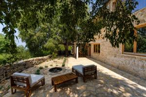 a patio with three benches and a fire pit at Villa Pueblo Karin in Gornji Karin +131 photos