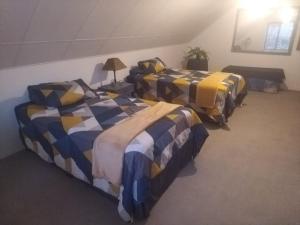 three beds lined up in a room at AtPeace in Ifafa Beach