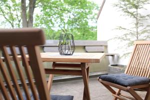 a wooden table with a glass bowl on top of it at Kleine BergZeit in Sankt Andreasberg