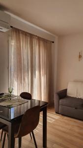 a living room with a table and a couch at Apparemment Centre ville Port-Vendres in Port-Vendres