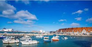 a group of boats in the water in a harbor at La Marée in Calais