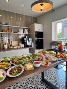 a buffet with many plates of food on a table at Pokoje Gościnne u Małgosi in Mielno