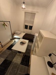 a small room with a bed and a table at Nordhavn Cozy Room in shared apartment in Copenhagen